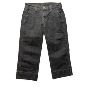 May include: A pair of dark charcoal gray corduroy pants featuring a straight-leg cut, a button and zipper fly closure, belt loops, and wide folded cuffs at the bottom hem. The fabric has a visible vertical ribbed texture throughout the garment.