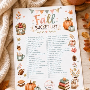 May include: A printed Fall Bucket List checklist on white paper featuring colorful illustrations of pumpkins, apples, a football, s'mores, and autumn leaves. The text includes a list of seasonal activities with checkboxes and a logo reading One Whimsy Day.