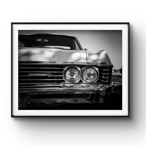 May include: A black and white framed wall art print featuring the front end of a classic Chevrolet Impala SS. The image highlights the dual circular headlights, the chrome front grille, and the Impala SS emblem centred on the front fascia.