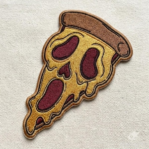 May include: An embroidered patch shaped like a slice of pizza with a skull-like face. The crust is brown, the cheese is yellow, and the deep red sauce forms two oval eyes and a long, open mouth, creating a screaming expression on the pizza slice.