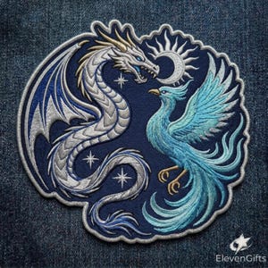 May include: A circular embroidered patch on a dark blue background featuring a silver dragon and a light blue phoenix facing each other. The design includes a crescent moon, small four-pointed stars, and the text ElevenGifts in the bottom corner.