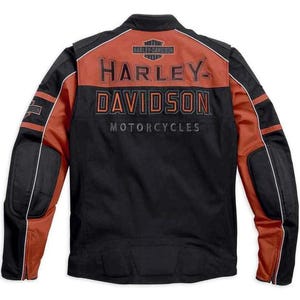 May include: A black and burnt orange motorcycle jacket featuring the Harley-Davidson logo and text on the back. The jacket includes padded elbow sections, zipped cuffs, and white piping accents along the sleeves and across the upper back panel.