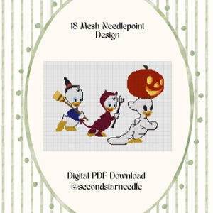 May include: A digital needlepoint pattern on a grid featuring three cartoon ducks in Halloween costumes: one as a witch with a broom, one as a devil with a pitchfork, and one as a ghost carrying a jack-o'-lantern. Text reads 18 Mesh Needlepoint Design.