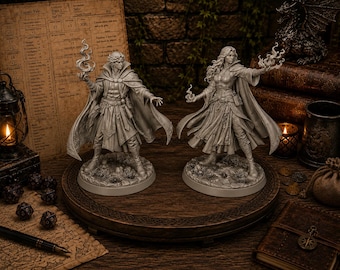 May include: Two unpainted grey resin tabletop gaming miniatures of spellcasters standing on circular bases. Each figure wears a long cloak and layered clothing, with one hand extended holding a sculpted magical flame effect. The figures are highly detailed.