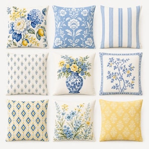 May include: A collection of nine square throw pillows featuring various patterns including blue and yellow floral bouquets, lemons, blue damask, blue and white vertical stripes, small blue sprigs, a blue vase, a tree motif, and yellow patterns.