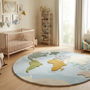 May include: A large circular area rug featuring a world map design with light blue oceans and continents in muted shades of green, yellow, and beige. The rug is positioned in the center of a room containing a wooden crib, a rocking chair, and a bookshelf.