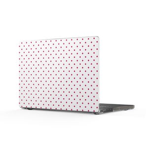 May include: A laptop computer featuring a protective hard shell case with a white background and a repeating pattern of small, evenly spaced dark pink polka dots covering the entire exterior surface of the lid and the base of the device.
