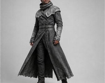 May include: A long, charcoal grey distressed coat featuring a high collar, structured shoulder panels, and a double-belted waist with circular buckles. The garment has a textured, weathered finish, long sleeves, and a floor-length hemline.