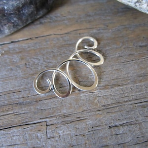 May include: Silver swirl design earring with multiple loops.