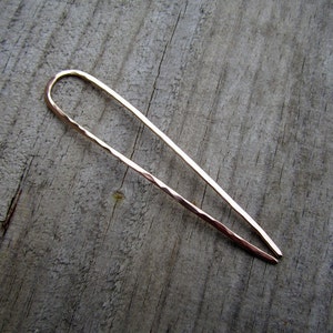 This is a handmade U shaped bronze hair fork pin. It is one continuous smooth piece of bronze wire which is hammered with gentle facets. The finish feels soft. the ends are very well polished, and will not snag the hair. You choose the length needed.