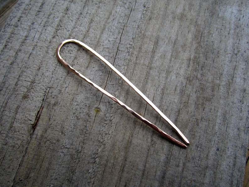 This is a handmade U shaped bronze hair fork pin. It is one continuous smooth piece of bronze wire which is hammered with gentle facets. The finish feels soft. the ends are very well polished, and will not snag the hair. You choose the length needed.