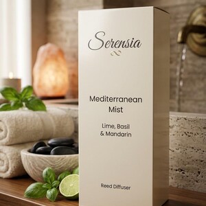 May include: A rectangular off-white reed diffuser box with the text Serensia, Mediterranean Mist, Lime, Basil & Mandarin, and Reed Diffuser printed in black. The packaging features a clean, vertical design with elegant typography on the front face.