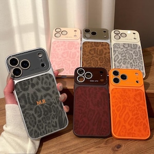 May include: A collection of six smartphone cases featuring a leopard print pattern and a camera lens cutout area with the text CASE AITO. The cases come in various colors including gray, pink, brown, white, dark red, and bright orange.