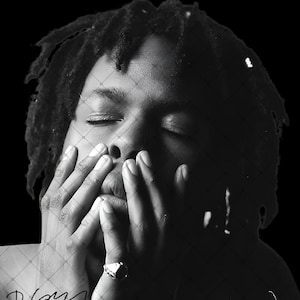 May include: A black and white portrait of a person with dreadlocks, eyes closed, with hands held up to the face. A metallic ring is visible on the finger. The image features a faint diamond-patterned overlay and a signature at the bottom left corner.