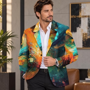 May include: A blazer featuring a vibrant, abstract brushstroke pattern in shades of orange, teal, yellow, and dark green. The garment has a notched lapel, a single-button closure, and long sleeves, worn over a crisp white button-down shirt.