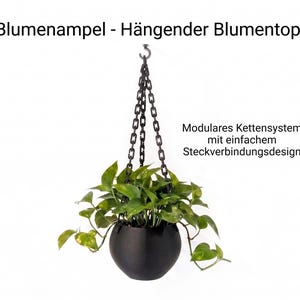 Könnte beinhalten: Ein schwarzer Hängeblumentopf mit modularem Kettensystem und einer grünen Efeutute. Der Text lautet: Blumenampel - Hängender Blumentopf und Modulares Kettensystem mit einfachem Steckverbindungsdesign. Der Topf ist an einer schwarzen Kette aufgehängt.