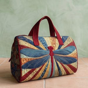 May include: A quilted handbag featuring a large dragonfly motif with blue wings and a red body. The bag has red handles and red piping, with a sunburst pattern in shades of yellow, orange, and blue. The text Design01 is visible in the corner.