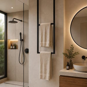 May include: A matte black metal towel rack mounted from the ceiling to the floor, featuring two horizontal bars holding two beige towels. The rack has a rectangular frame design and is positioned in a bathroom next to a shower and vanity.