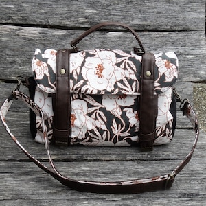 Sac à main cartable femme avec bandoulière réglable et amovible en faux cuir marron et tissu noir avec de grandes fleurs blanches et cognac