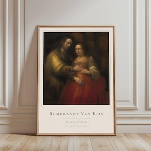 Può includere: Una stampa d'arte incorniciata che riproduce il dipinto La sposa ebrea di Rembrandt van Rijn. L'immagine mostra un uomo in tunica dorata e una donna in abito rosso. Sotto l'opera, il testo recita: REMBRANDT VAN RIJN, The Jewish Bride, FINE ART COLLECTION.