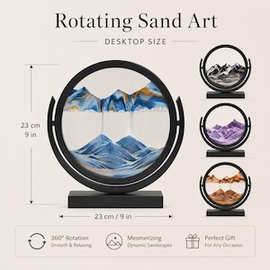 May include: A circular rotating sand art display with a black frame and base, measuring 9 inches in height and width. The glass contains blue, white, and gold sand forming mountain landscapes. Text includes Rotating Sand Art and Desktop Size.