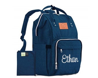 May include: A dark blue diaper bag backpack with a zippered pocket and a white embroidered name "Ethan". The bag has a matching dark blue changing mat.