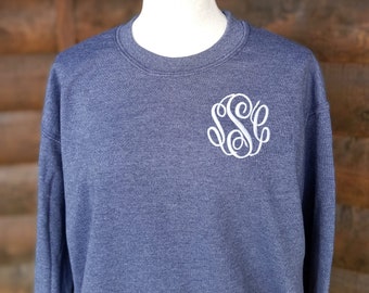 May include: A blue heather sweatshirt with a white embroidered monogram on the left chest.