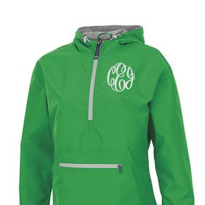 May include: Bright green anorak jacket with a white monogram on the chest. The jacket has a hood, a half-zip closure, and a front pocket with a zipper. The text "Pretty Personal Gifts" is at the bottom.