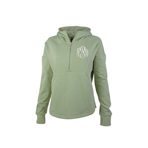 May include: Sage green hooded sweatshirt with a quarter-zip closure and a kangaroo pocket. Features a white monogram on the front. The long sleeves have thumb holes at the cuffs. The sweatshirt is made of a soft, comfortable material.