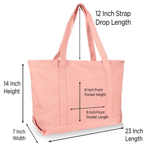 May include: A light pink canvas tote bag with two shoulder straps. Dimensions are labeled as 14 inch height, 23 inch length, 7 inch width, 12 inch strap drop length, and an 8 inch by 8 inch front pocket.