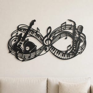 May include: A black metal wall art piece shaped like an infinity symbol, featuring an electric guitar, a vinyl record, piano keys, a treble clef, musical notes, a saxophone, and a microphone integrated into the continuous looping design.