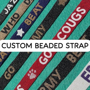 May include: A collection of custom beaded straps in various colors including black, red, blue, gold, and white. Each strap features embroidered text such as GO COUGS, BEAT, and ARMY, along with symbols like stars and a paw print. The text CUSTOM BEADED STRAP is centered.