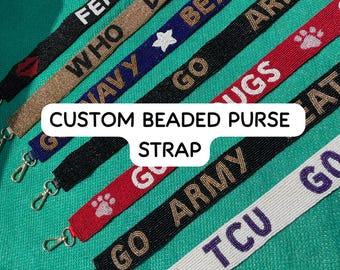 May include: A collection of custom beaded purse straps featuring various colors and designs, including text such as WHO, GO, HUGS, GO ARMY, and TCU, along with icons like a red lip, a white star, and a white paw print, all with metal swivel clasps.
