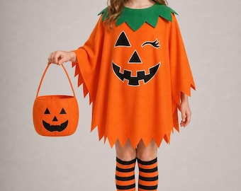 May include: An orange pumpkin poncho costume featuring a jagged hem, a green collar, and a jack-o'-lantern face print. The outfit includes a matching pumpkin headband, black and orange striped knee-high socks, and an orange pumpkin treat bucket.