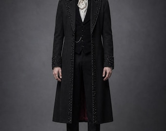 May include: A black long coat featuring intricate beadwork along the lapels and cuffs, worn over a black vest, white cravat with a dark brooch, and black trousers. The ensemble includes a black top hat and black leather boots, creating a formal look.