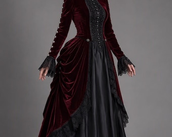 May include: A floor-length gown featuring a deep burgundy velvet bodice with a high collar, long sleeves with silver buttons, and black lace trim. The skirt consists of a draped burgundy velvet overskirt layered over a solid black satin underskirt.