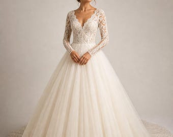 May include: A floor-length ivory wedding dress featuring long lace sleeves, a deep V-neckline, and a fitted bodice with intricate floral lace detailing. The full, voluminous skirt is made of layered tulle with a wide lace border along the hemline.