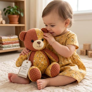 May include: A stuffed teddy bear featuring a patchwork design of mustard yellow fabric with a white floral print and rust-coloured fabric with white polka dots. A beige tag attached to the bear reads THE MEMORY BEAR (Handmade Pattern Project).
