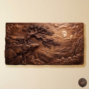 May include: A rectangular wooden wall art piece featuring a detailed relief carving of a tree growing on a rocky cliffside. The scene includes a full moon in the sky, swirling clouds, and mountain peaks. A small circular logo is in the bottom right corner.