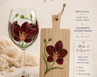 May include: A gift set featuring a clear wine glass and a rectangular wooden board, both hand-painted with dark red orchid flowers. The wine glass is 22 cm tall with a 600 ml capacity, and the wooden board measures 20 x 10 x 1 cm.