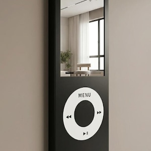 May include: A rectangular wall mirror with a black frame designed to resemble a digital music player. The upper portion is a reflective glass surface, while the lower section features a large white circular control wheel with the text MENU.