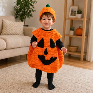 May include: A bright orange crochet pumpkin costume featuring a sleeveless tunic with a black jack-o'-lantern face and a matching orange beanie with a green stem. The outfit is worn over a black long-sleeved shirt and black leggings.