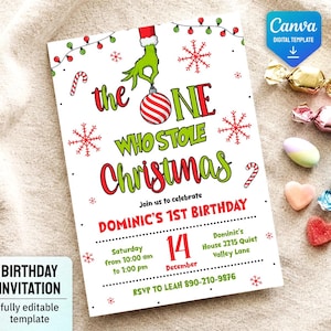 May include: A white birthday invitation card featuring a green hand holding a red and white striped ornament. The text reads: the ONE WHO STOLE Christmas, Join us to celebrate DOMINIC'S 1ST BIRTHDAY, Saturday December 14, and contact details.