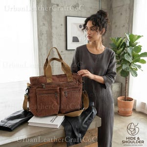 May include: A brown corduroy tote bag featuring two front zippered pockets, two top handles, and a detachable shoulder strap. The bag has a rectangular shape with visible vertical ribbing throughout the fabric and metal zipper hardware.
