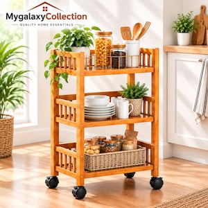 May include: A three-tier bamboo rolling cart with four black caster wheels. The top shelf holds glass jars with pasta and coffee beans, a white utensil holder, and a green plant. The middle shelf holds white plates and a mug. The bottom shelf holds jars.