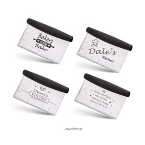 May include: Four stainless steel bench scrapers with black handles. Each scraper has a different design and text: "Bakery Gonna Bake", "Chef Dale's Kitchen", "Sunny's Kitchen Made With Love", and "Mom, We love you to the moon & back."