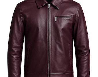 May include: A deep burgundy jacket with a smooth finish, featuring a classic collar, a full-length center front zipper, long sleeves with cuffs, and a single horizontal zippered chest pocket on the left side, all presented against a plain white background.