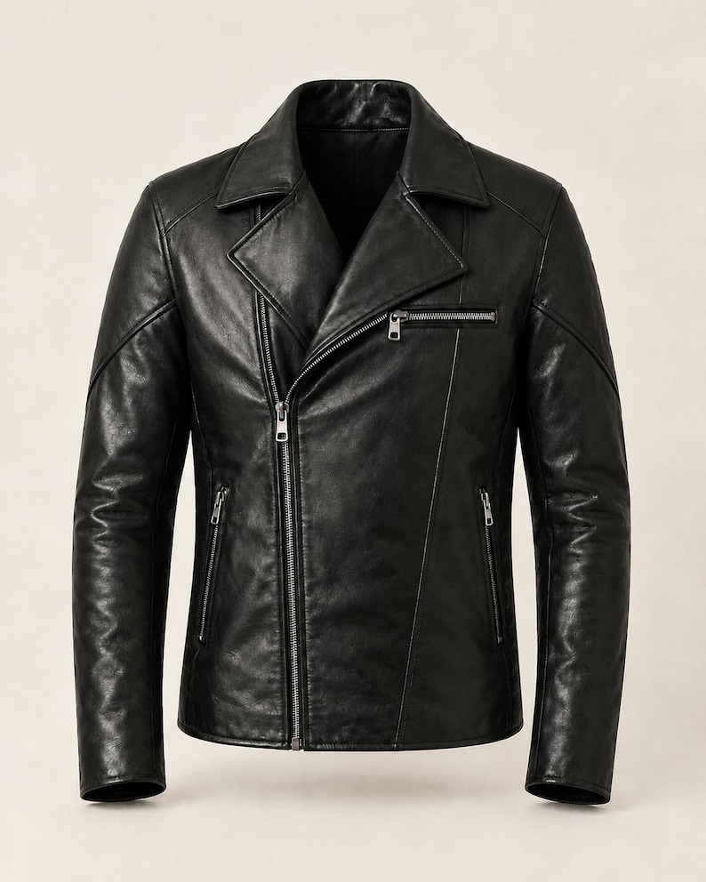 May include: A black leather jacket featuring a wide notched lapel, an asymmetrical front zip fastening, and three zipped pockets on the front. The jacket includes long sleeves with structured shoulder panels and silver-toned metal hardware.