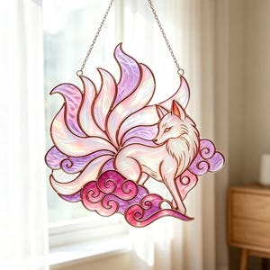May include: A stained glass suncatcher featuring a nine-tailed fox with iridescent white and purple glass panels. The fox is depicted standing on stylized purple and pink clouds, with a metal chain attached to the top for hanging purposes.