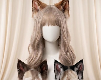 May include: A white mannequin head wearing a long, wavy, light brown wig with bangs and a pair of brown faux fur animal ears. Two additional pairs of faux fur ears, one brown and one black and white, are displayed on clear stands in front.